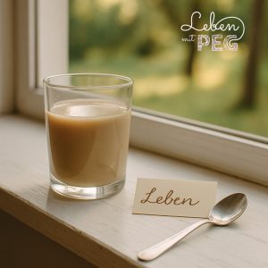Glas mit Sondennahrung auf Fensterbank neben Löffel und Kärtchen mit dem Schriftzug „Leben“